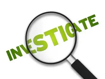 Magnifying glass highlighting the word "Investigate" in green, symbolizing deep inquiry and analysis in the countries we operate in.